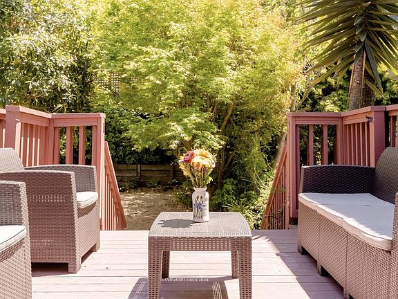 The private deck is located right off of the kitchen and opens to the shared garden.