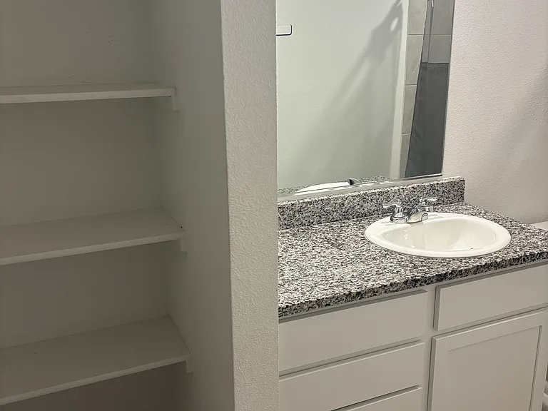 Master Bathroom comes with shelves for storage.