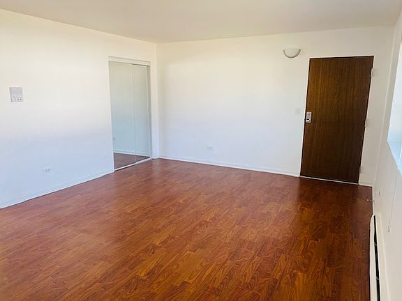 Another view of the front room with front, mirrored storage closet.