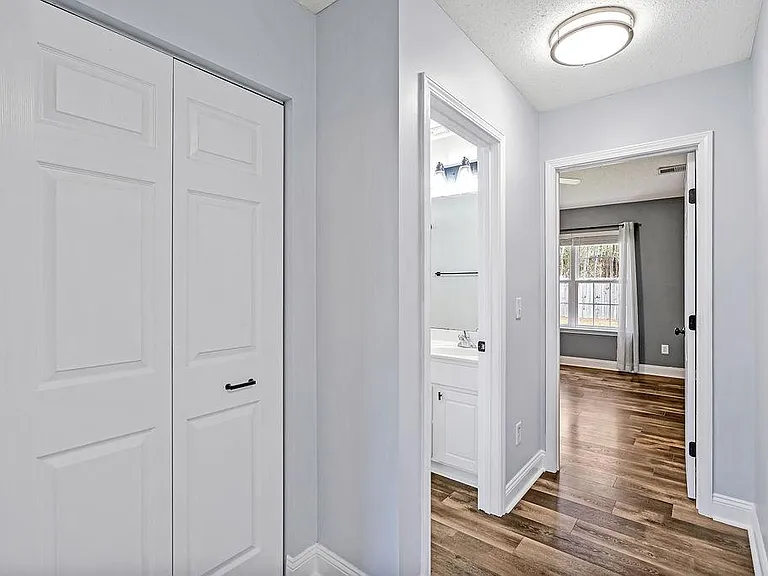 Hallway to the master bedroom ahead. Linen closet to the left followed by a bathroom.
