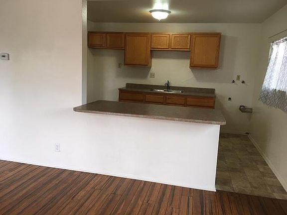 Kitchen with stack-able washer and dryer hook ups .