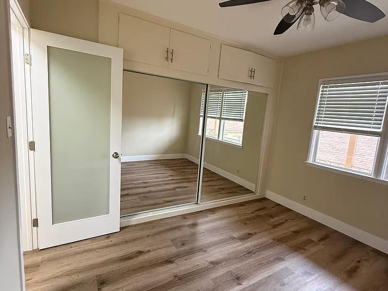 Bedroom with mirrored closet doors