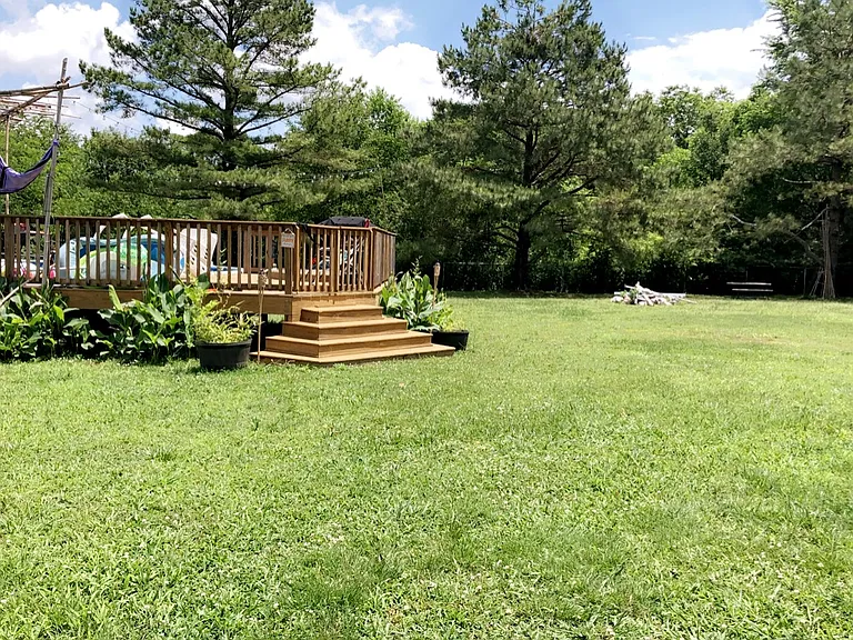 Back yard, home sits on over an acre. Landlord will do grass and weed eating.