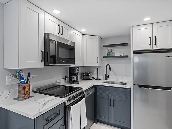 Kitchen includes fridge/freezer, stove, oven, coffee maker, toaster, microwave, and all cutlery/crockery needed for cooking and eating.