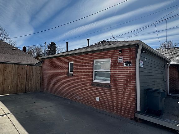 Side of house off alley, parking space next to house, motion lights, and Ring Camera.