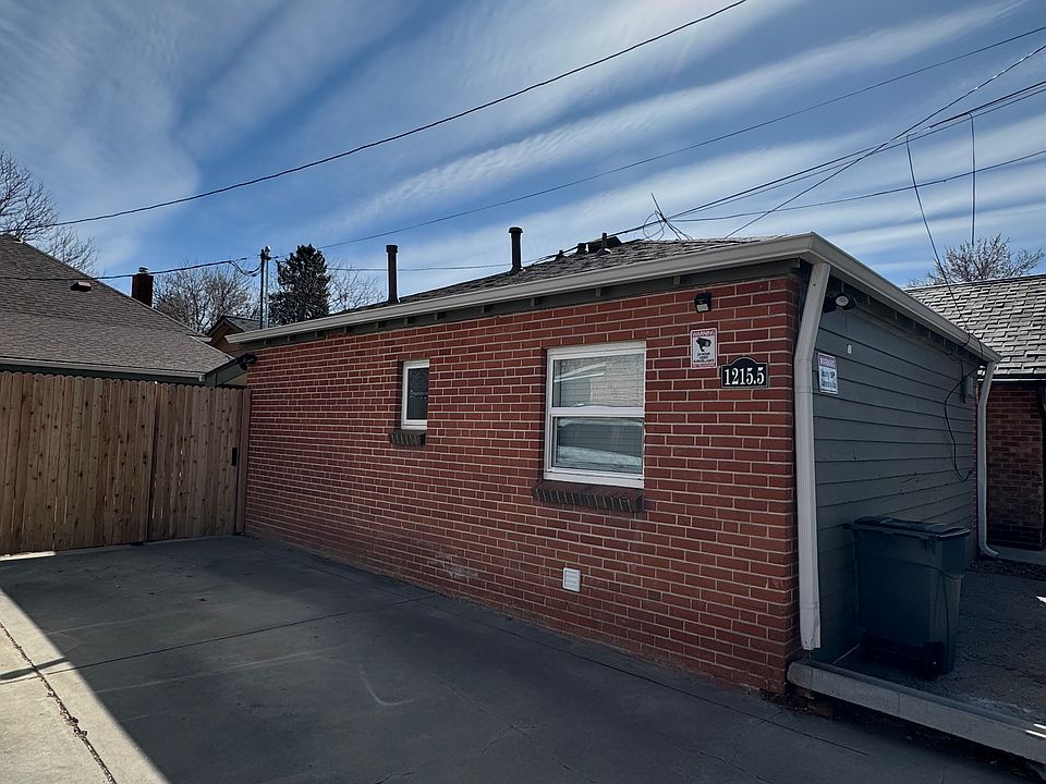 Side of house off alley, parking space next to house, motion lights, and Ring Camera.