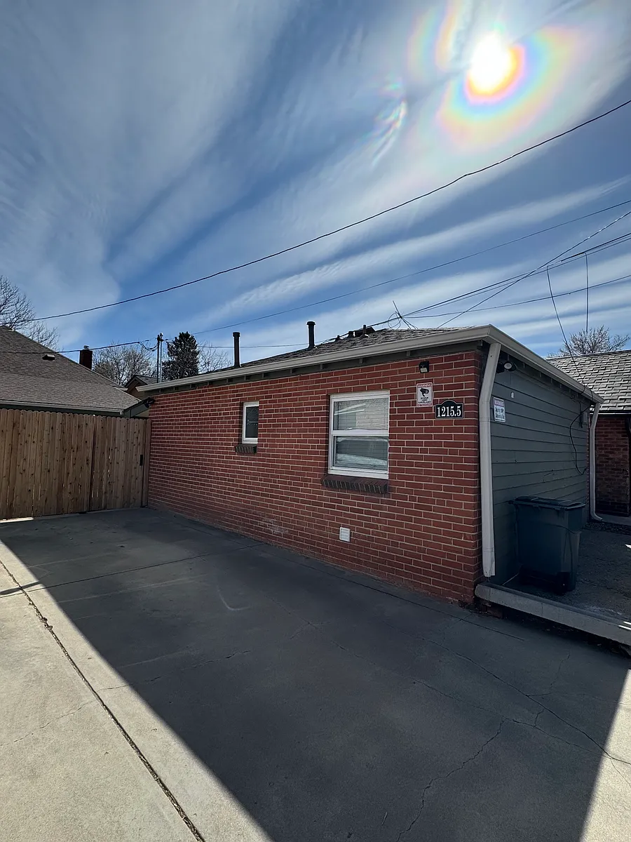 Side of house off alley, parking space next to house, motion lights, and Ring Camera. - 1215 1/2 S Emerson St #1