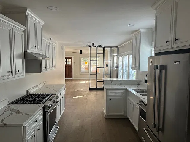 View of Kitchen, dining room and living room while standing an entry of pantry.