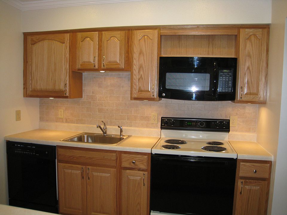 Brand new ceramic tiled backsplash with undercabinet lightin