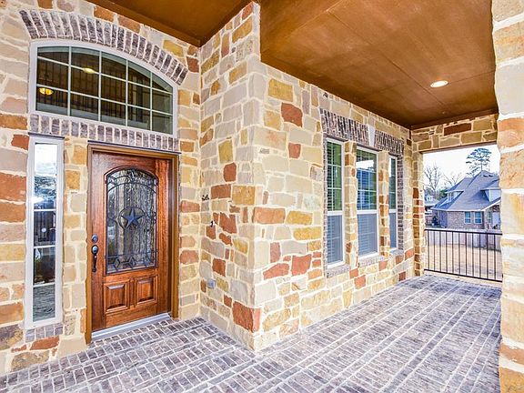 Full brick flooring at both front and back porches. Beautiful brick & stone elevation!