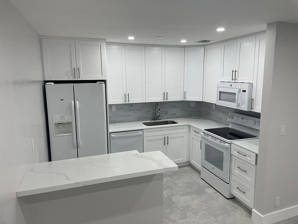 Completely remodeled kitchen with new cabinets, dishwasher, stove, microwave. Quartz countertop