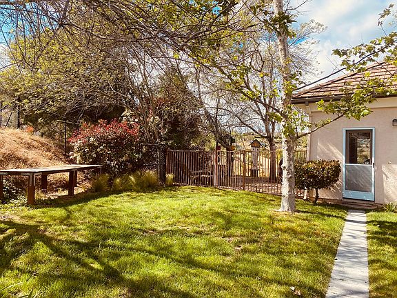 2 Greeting you home, a green, sunny and blue-skied entrance. To the left is your dedicated patio area. BBQ anyone?