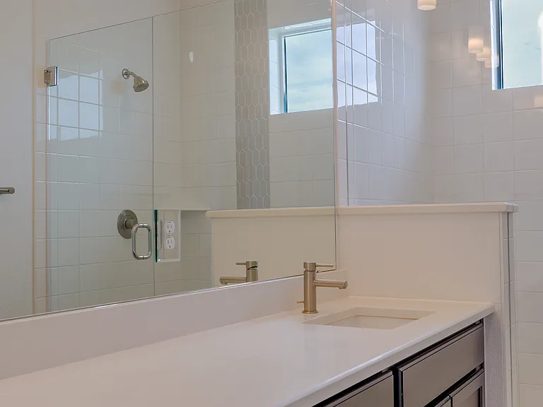 Spacious master bathroom with elegant finishes, dual sink and glass enclosed shower