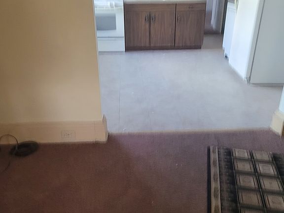 Large living room with open area leading into the kitchen