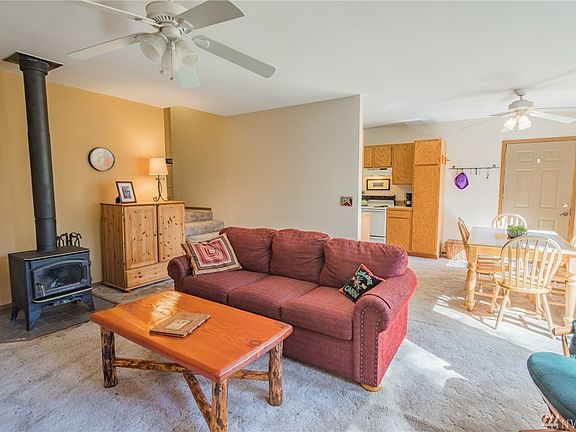 Upper level living space opens to dining & kitchen area. Nice wood burning free standing stove, and large front deck!