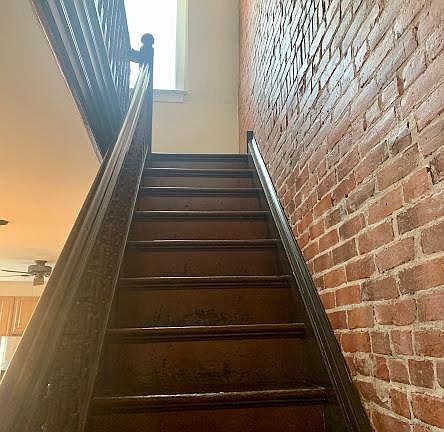 Exposed brick stairway up to the apartment