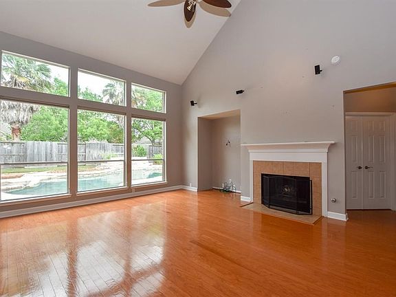 Comfortable space with gas fireplace and tall ceilings.