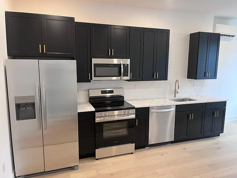 Designer Kitchens: High-end quartz countertops, elegant shaker cabinetry, custom tile backsplashes, and full-size stainless steel appliances. *Layout presented is from apartment 2 - each unit has a unique kitchen layout*
