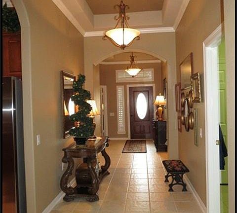 ENTRY WITH RECESSED CEILING WITH CROWN MOLDING AND TILE FLOORS.