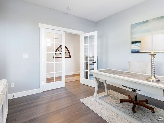 French doors lead to the spacious main floor den.>