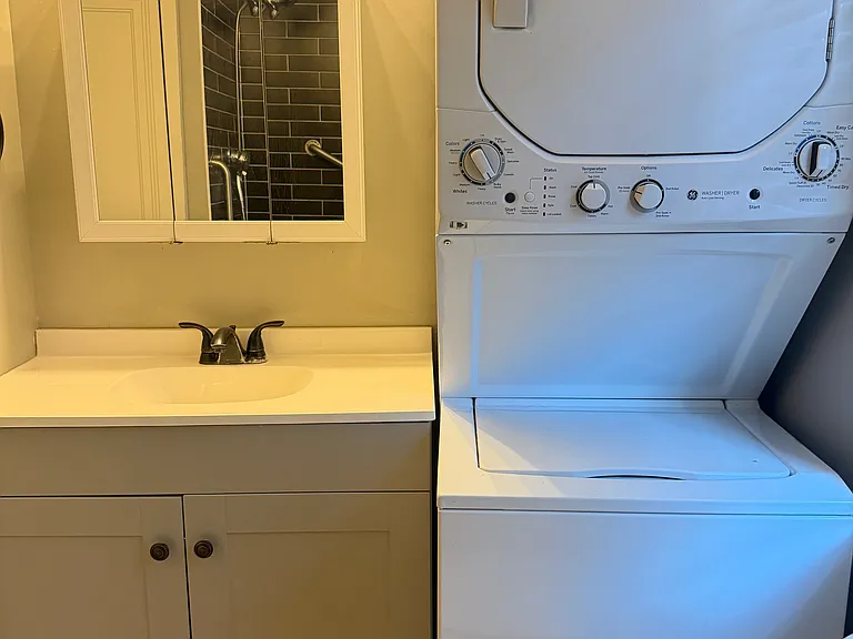 Bathroom with in-unit washer/dryer.
