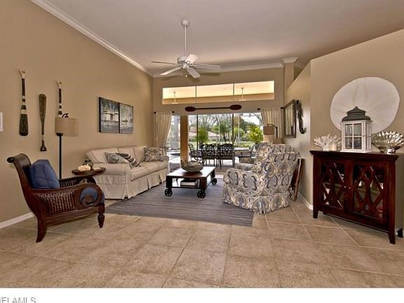 Foyer leads to the living room with views of lake and pool.