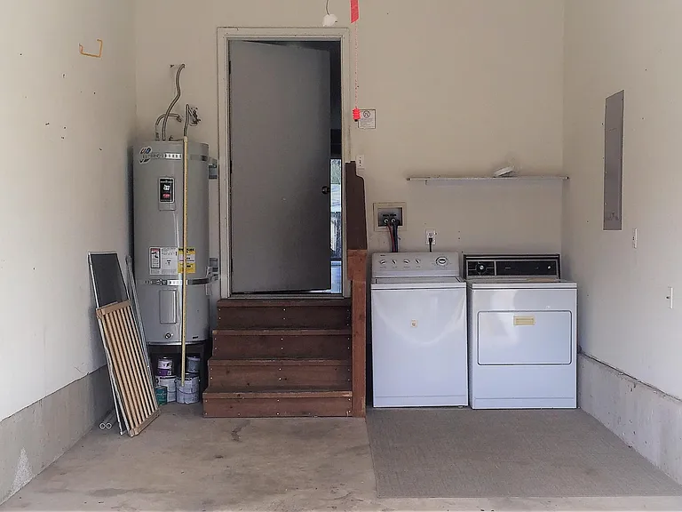 One-car garage with new water heater and laundry. Parking for a second car in driveway.