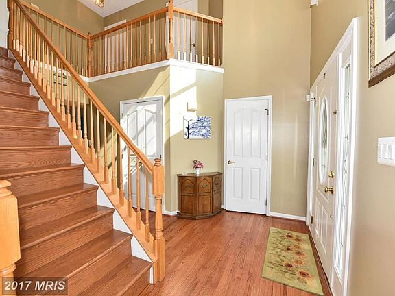 2 Story Foyer w/Hardwood Floors and Oak Stairway