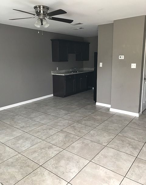 Living room at front door looking to the kitchen
