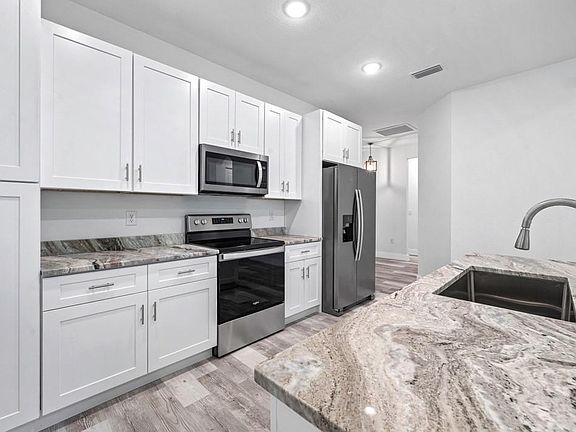 Very functional kitchen designed with workflow in mind. Meal preparation and clean up will be a breeze in this lovely space.