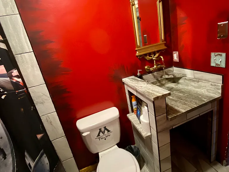 Bathroom features a one of a kind, magical, infinity sink and a tiled tub/shower combo.