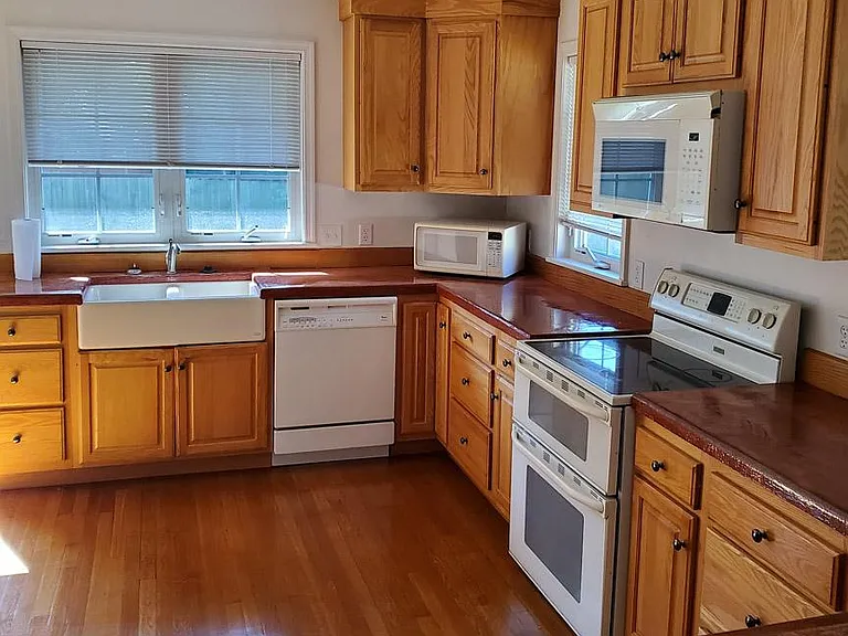 Open plan kitchen, separated from living room by peninsula island.