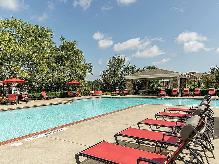 Relax and unwind in this luxurious poolside setting, surrounded by lush greenery and modern comforts.