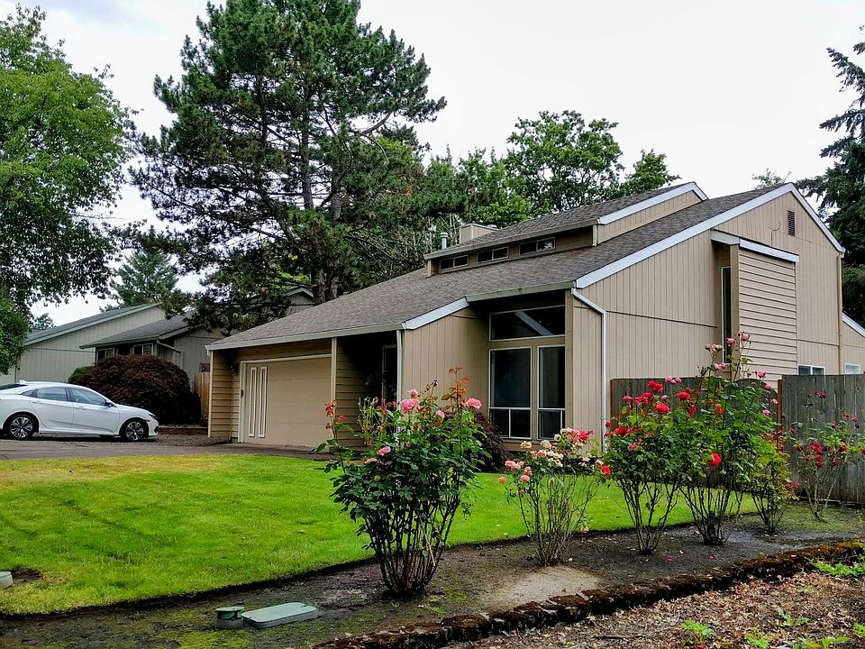 Rose bushes and large lawn in the front.
