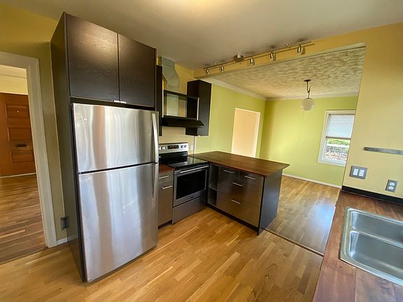 New stainless appliances, bar counter seating, dining room