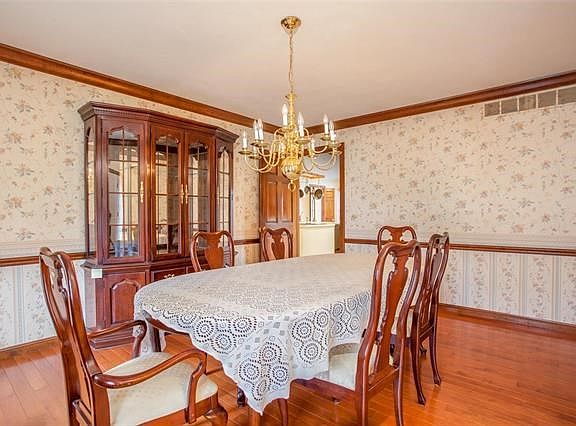 Traditional formal dining room with chair rail and crown molding add a touch of elegance.