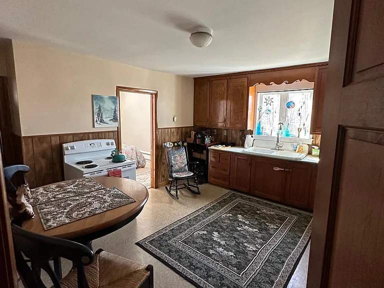 View of the kitchen while the current tenant is occupied. Furnishings not included. Washer & Dryer hookups in Kitchen.
