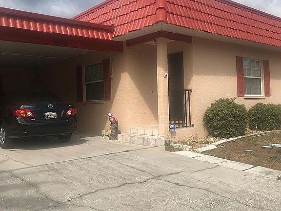 Front view includes carport 