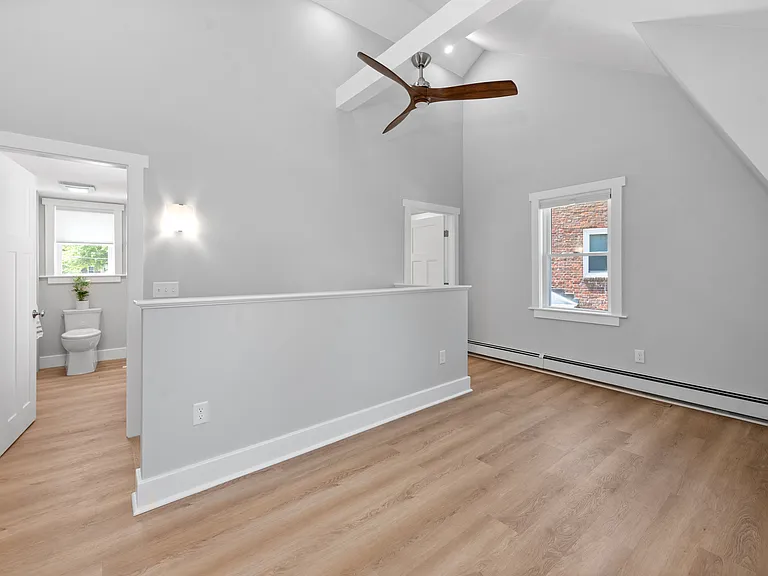 Spacious bedroom with high ceilings and plenty of natural light.