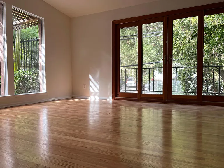 Livingroom with doors opening to front balcony.