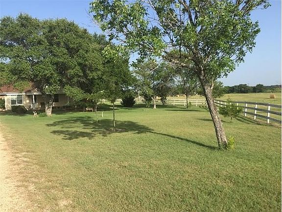 Beautiful trees invite you into the front yard.