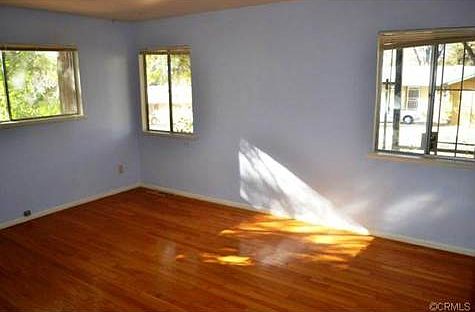 The front bedroom is quite large with hardwood flooring and a wa