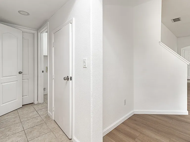 downstairs hallway to full bathroom, laundry room, and bedroom