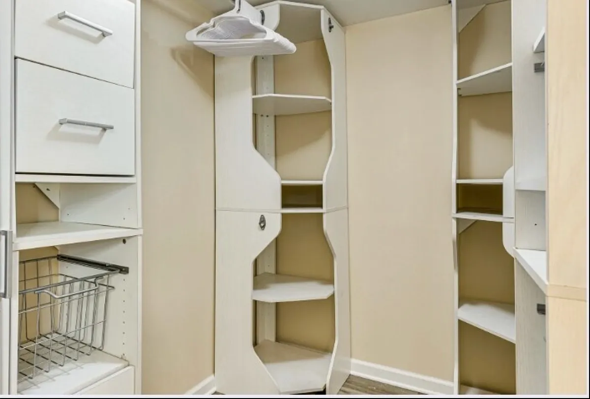 Spacious master bedroom with walk-in closet featuring built-in organizers for easy storage. - 1108 Valley View Ave