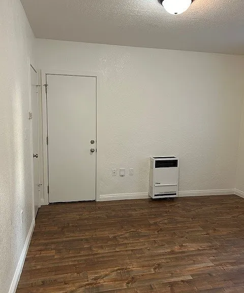 Bedroom with closet, A/C window unit, & access to private back patio