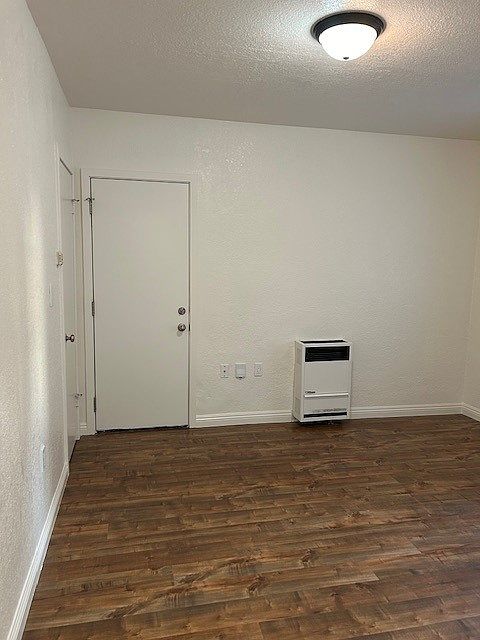 Bedroom with closet, A/C window unit, & access to private back patio