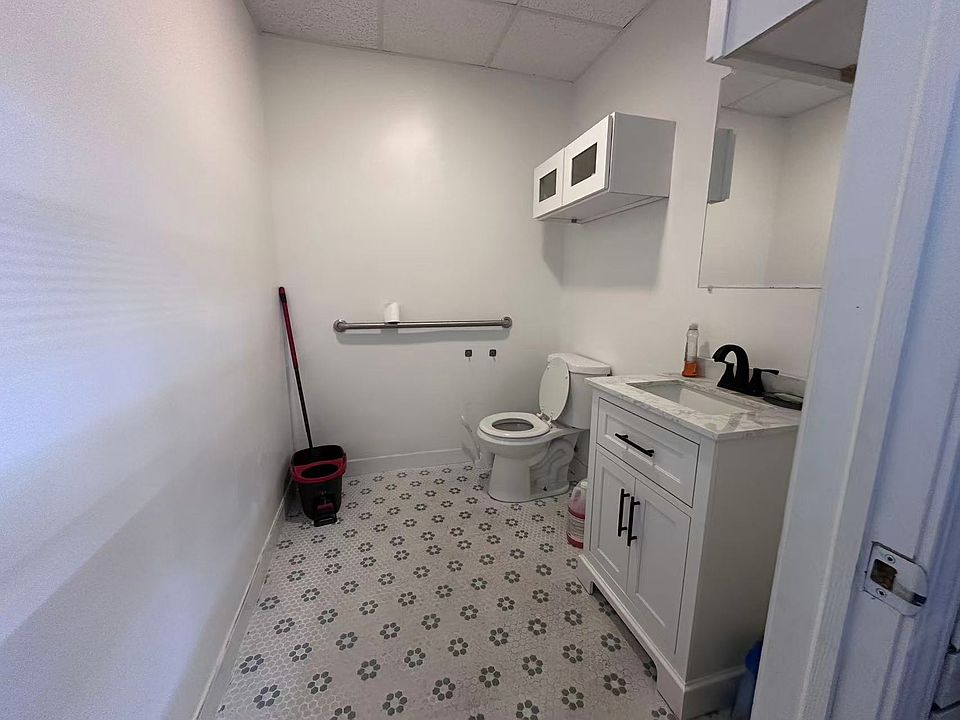 Clean and modern half bathroom with new vanity and fixtures.