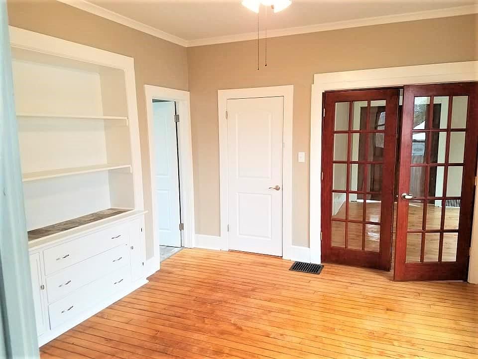 Dining room with built-in hutch, maple floors, and French doors