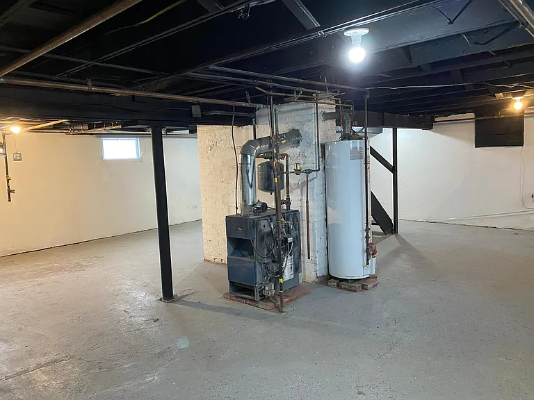 Hot water heater, Boiler and roof replaced in 2024. Plenty of space in full basement.