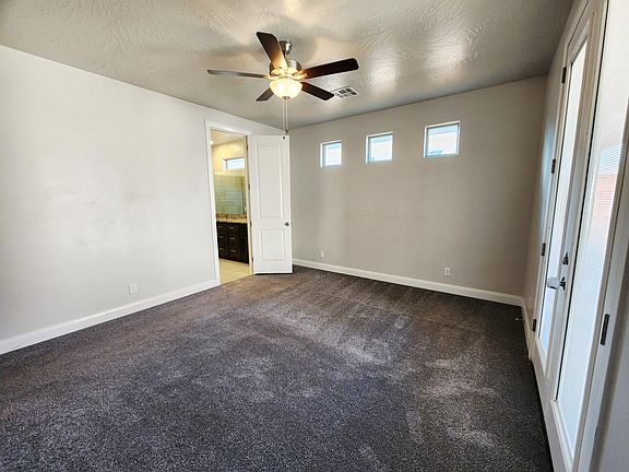 Large master bed with access to backyard